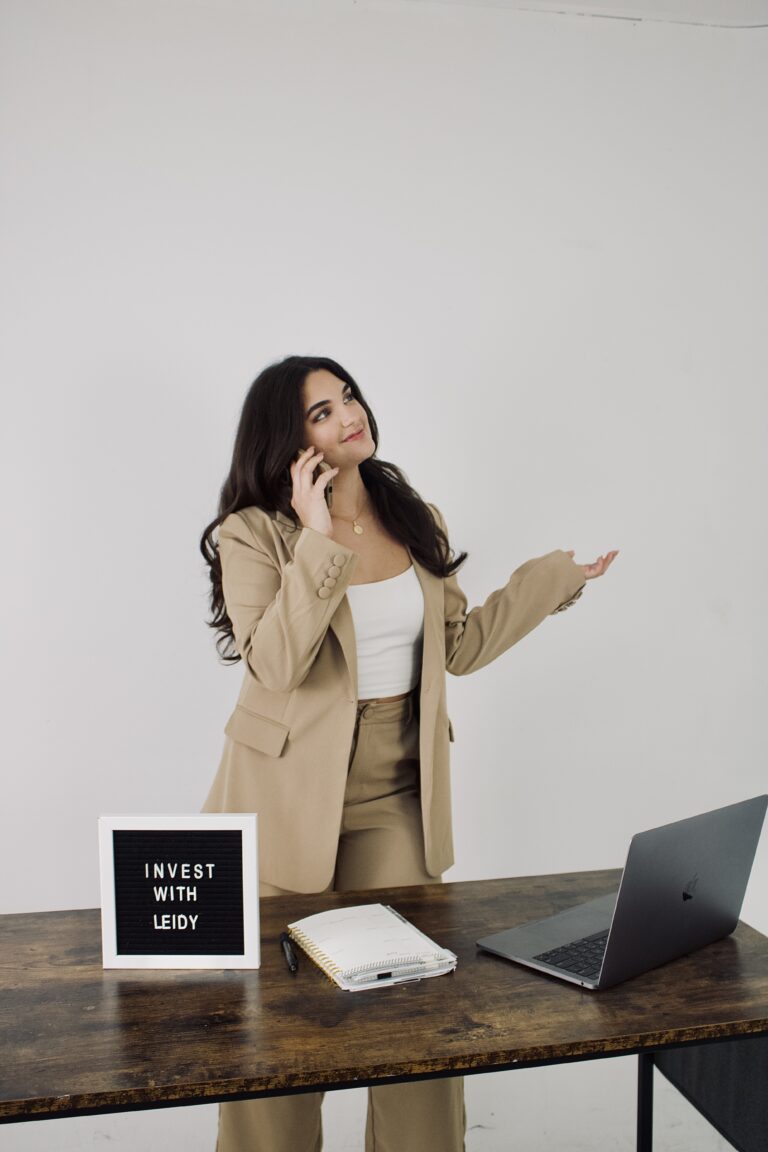 Leidy Melian, Southwest Florida Realtor and real estate investor, speaking on the phone at her desk.